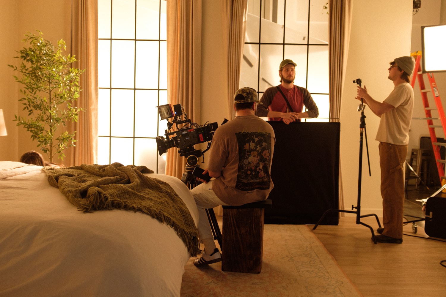 Crew operating a cinema camera on the studio floor.