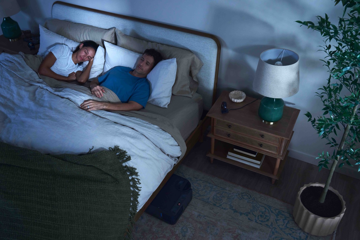 Couple asleep together in a cool, calm bedroom.