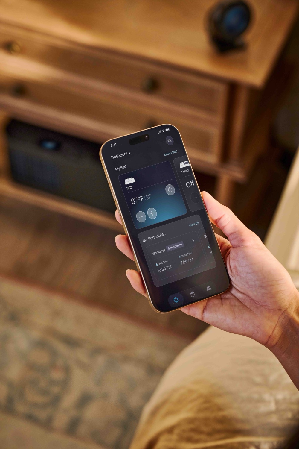 Hand holding a phone with the ChiliPad app dashboard.